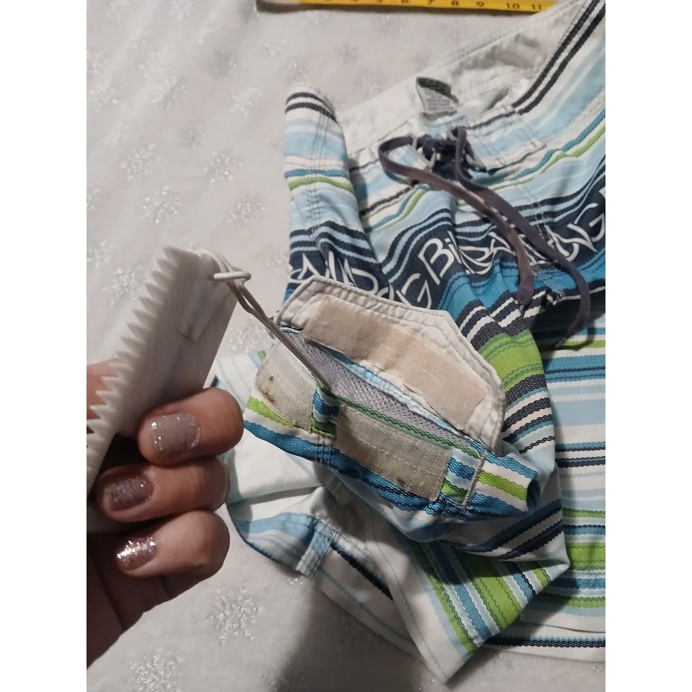 Billabong Board Shorts Size 30 with an attached fire starter and bottle opener